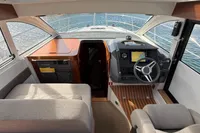 Interior of 2024 Nimbus 305 Coupe, featuring modern helm and comfortable seating.