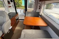 Interior of 2024 Nimbus 305 Coupe, featuring a cozy dining area and modern kitchen amenities.