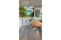 2024 Nimbus 305 Coupe interior with wooden flooring and seating area.