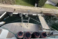 2024 Nimbus 305 Coupe docked, featuring a wooden deck and mooring equipment.