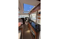 Luxurious interior of 2024 Nimbus 305 Coupe with skylights and modern kitchen amenities.