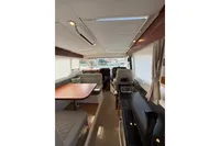 Interior of 2024 Nimbus 305 Coupe, featuring modern kitchen and seating area.