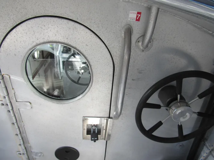 Silverado Yacht Photos Pics Pilothouse Cutter 2009 interior with porthole and steering wheel.