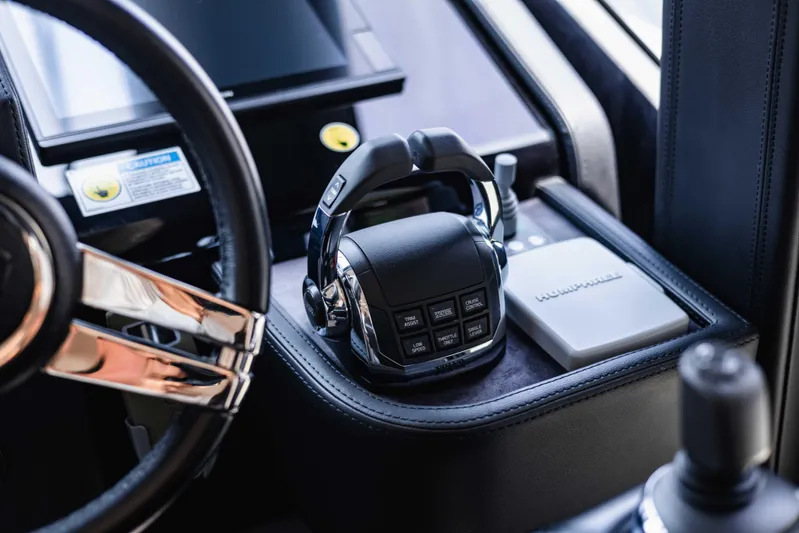  Yacht Photos Pics Control panel of 2019 Cranchi E 52F yacht with steering wheel and throttle controls.