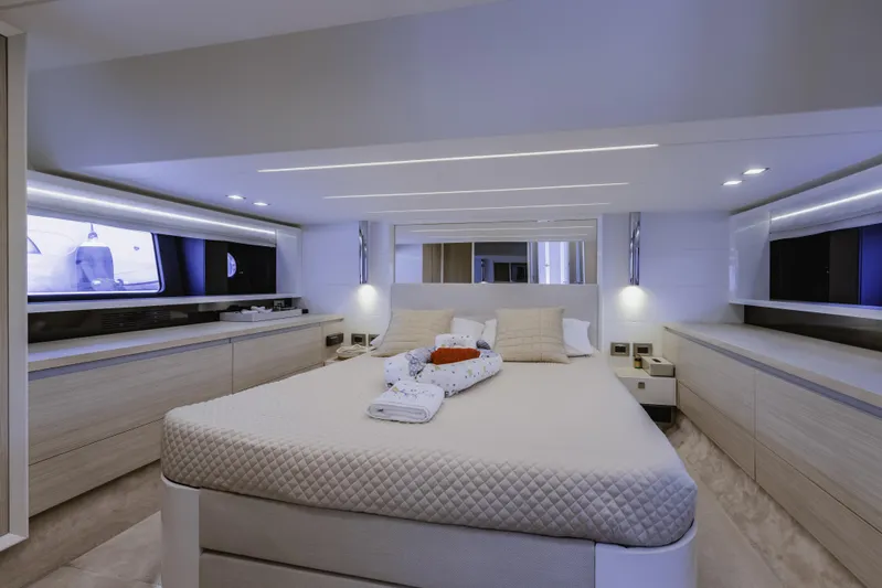  Yacht Photos Pics Luxurious bedroom interior of 2019 Cranchi E 52F yacht with modern design and ambient lighting.