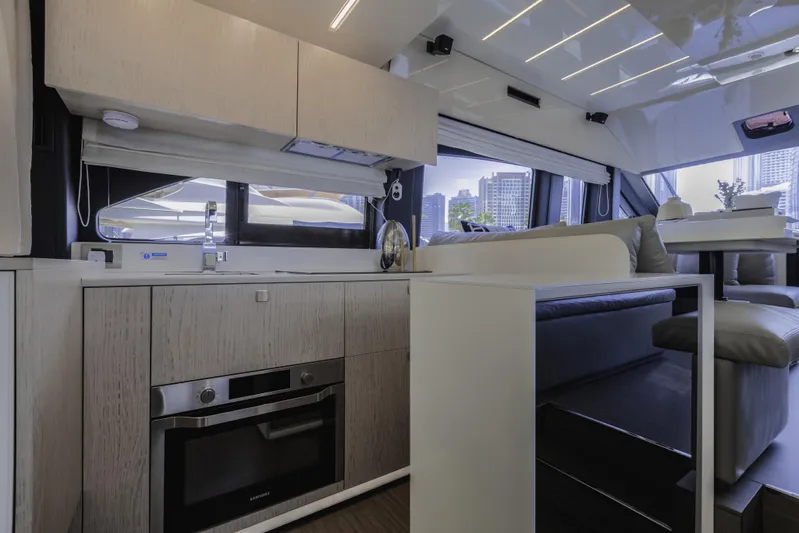  Yacht Photos Pics Luxurious interior of 2019 Cranchi E 52F yacht with modern kitchen and seating area.