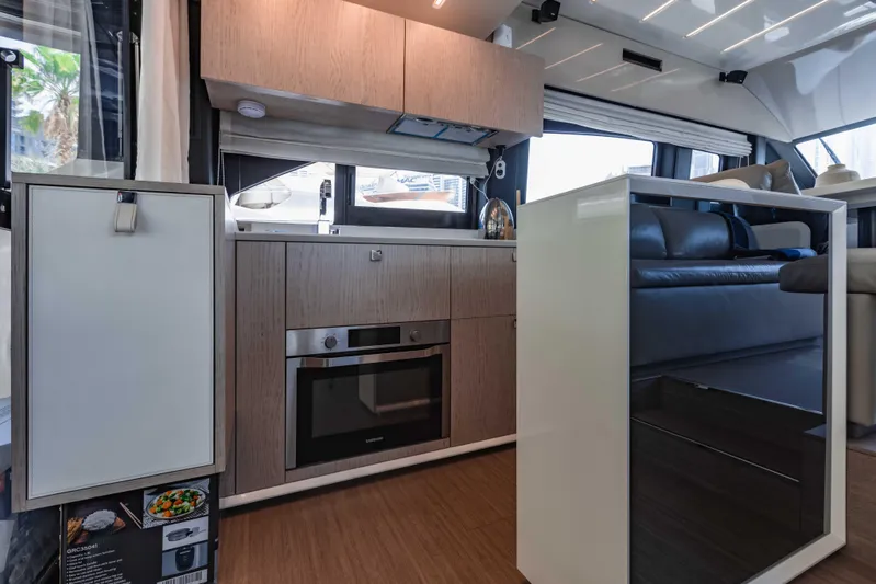  Yacht Photos Pics Modern kitchen interior of 2019 Cranchi E 52F yacht with sleek cabinetry and appliances.