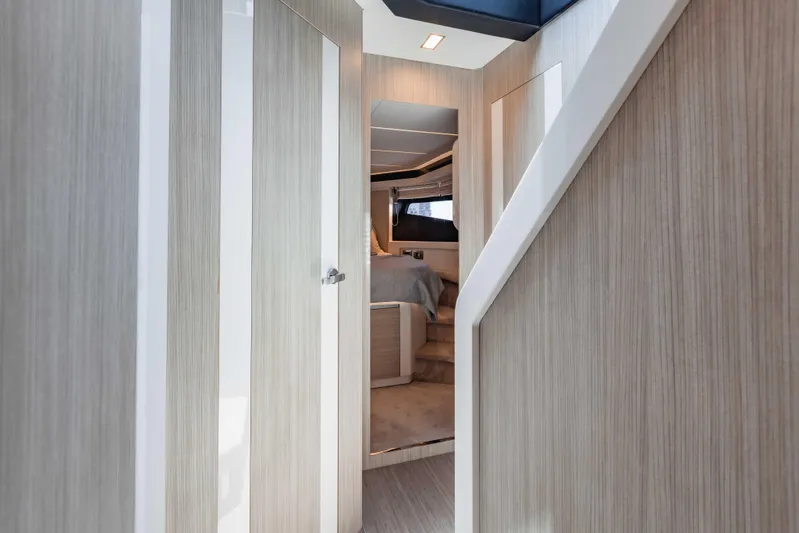  Yacht Photos Pics Interior of 2019 Cranchi E 52F yacht, featuring modern wood paneling and cozy bedroom.