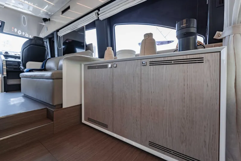  Yacht Photos Pics Luxurious interior of 2019 Cranchi E 52F yacht with modern cabinetry and seating.