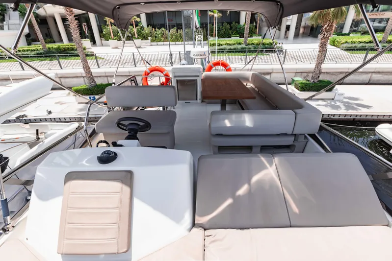  Yacht Photos Pics 2019 Cranchi E 52F yacht deck with seating and helm, docked in a marina.