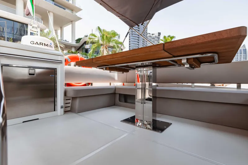  Yacht Photos Pics 2019 Cranchi E 52F yacht deck with wooden table and modern seating area.