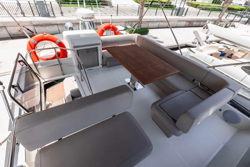  Yacht Photos Pics Luxurious 2019 Cranchi E 52F yacht deck with seating and wooden table.