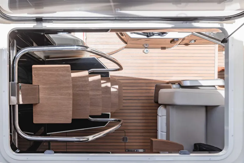  Yacht Photos Pics Interior view of 2019 Cranchi E 52F yacht with wooden stairs and seating.