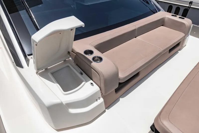  Yacht Photos Pics 2019 Cranchi E 52F yacht seating area with cup holders and storage compartment.