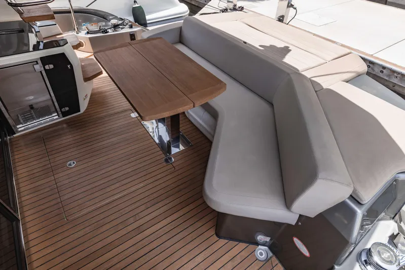  Yacht Photos Pics 2019 Cranchi E 52F yacht interior with sleek seating and wooden table.