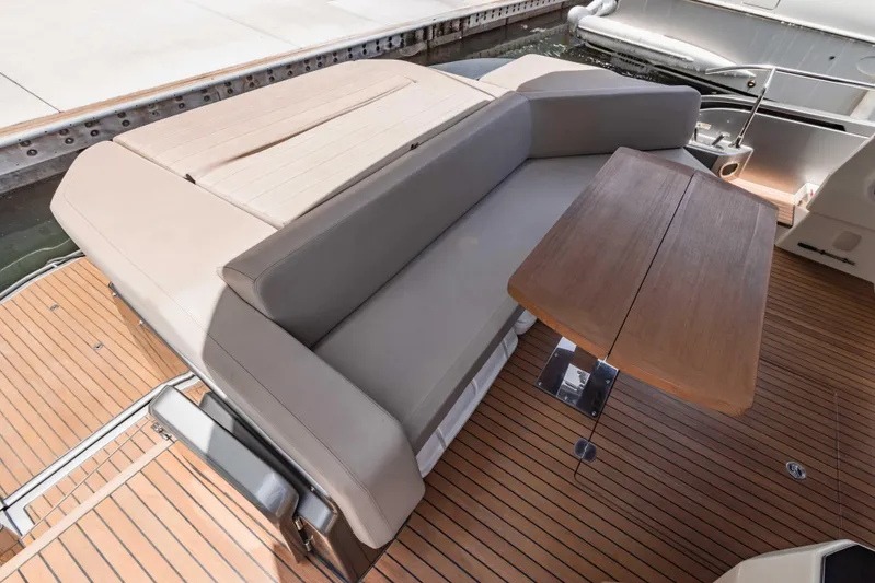  Yacht Photos Pics Luxurious 2019 Cranchi E 52F yacht with elegant seating and wooden table on deck.