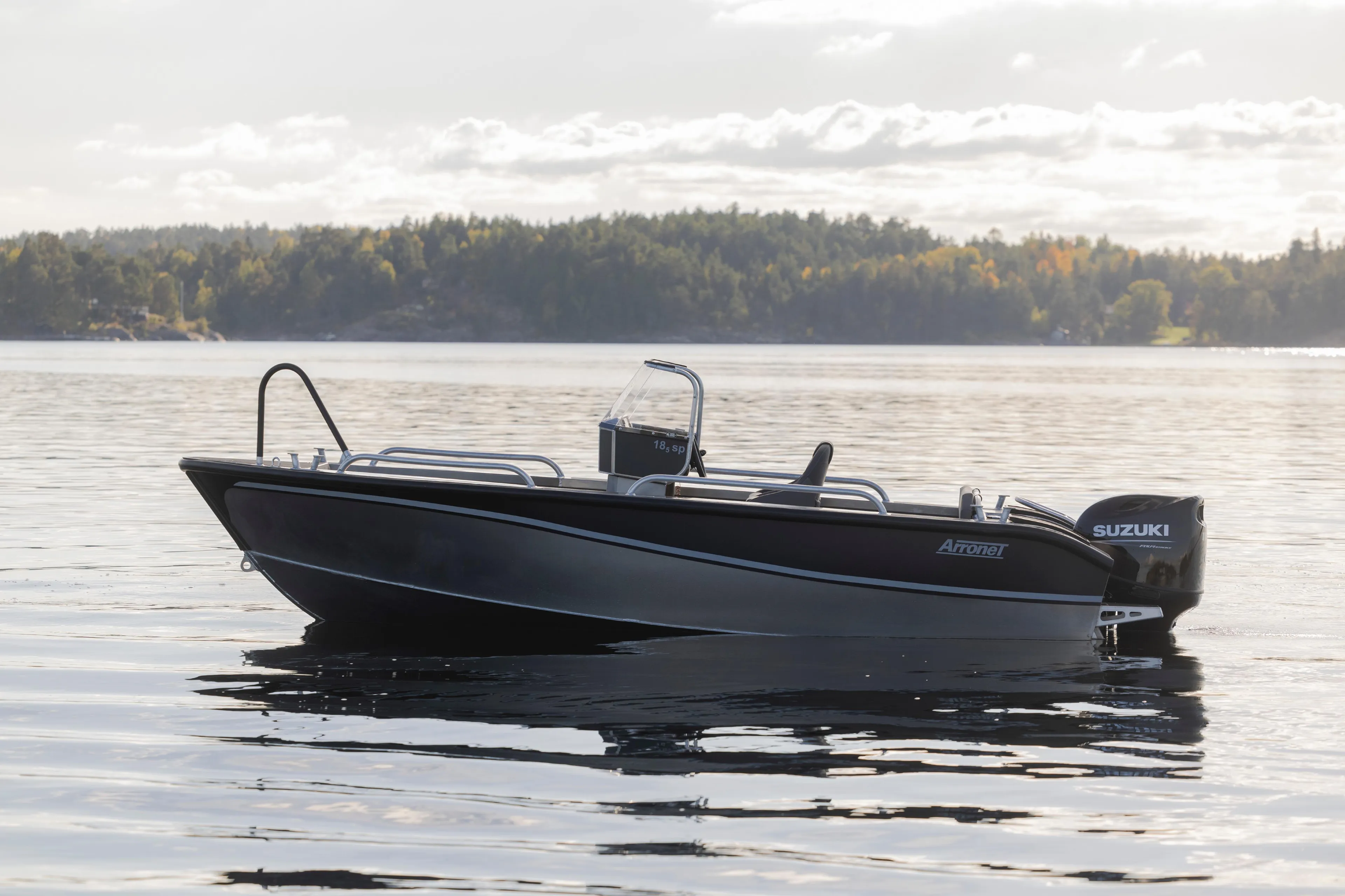 2025 Arronet 18 SP boat on calm water with scenic forest background.