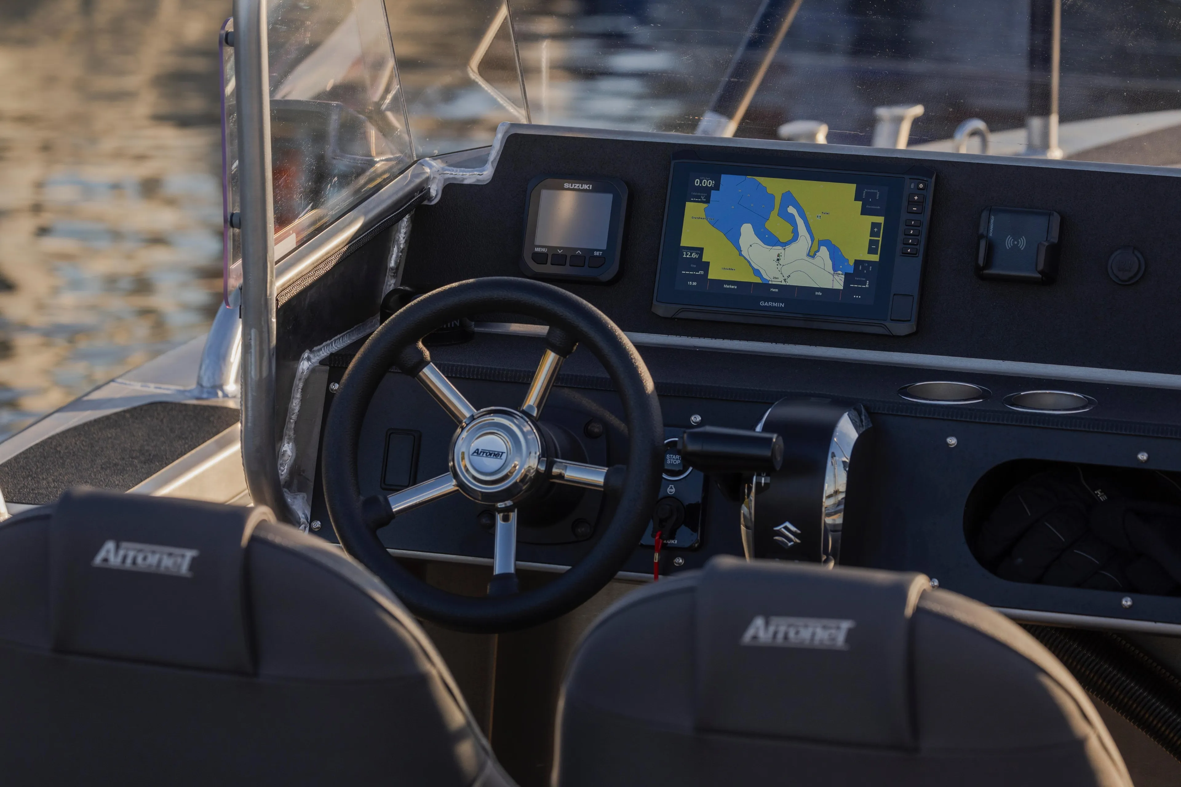 Cockpit of 2025 Arronet 18 SP boat with navigation display and steering wheel.