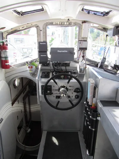Silverado Yacht Photos Pics Pilothouse interior of 2009 Custom Pilothouse Cutter with navigation equipment and steering wheel.