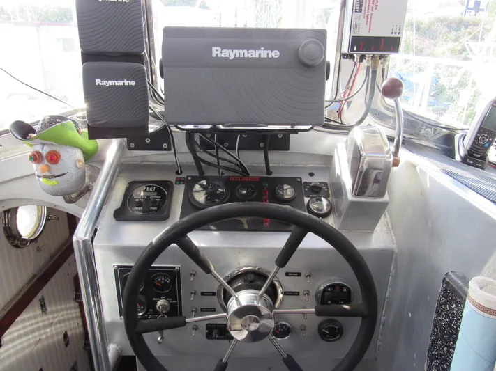 Silverado Yacht Photos Pics Pilothouse Cutter 2009 helm with Raymarine equipment and steering wheel.