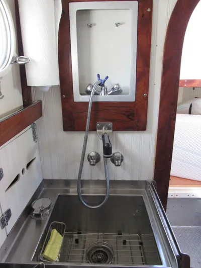 Silverado Yacht Photos Pics 2009 Custom Pilothouse Cutter interior with stainless steel sink and wooden accents.