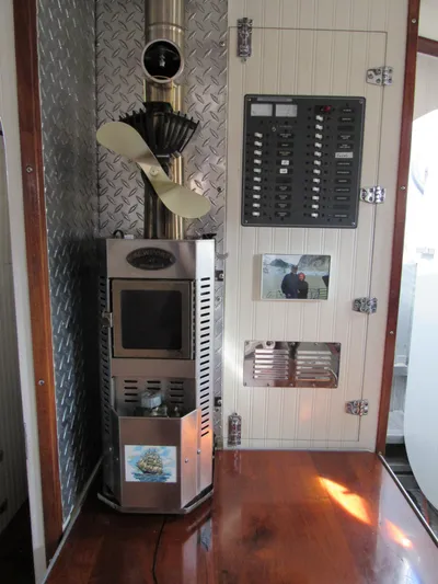 Silverado Yacht Photos Pics 2009 Custom Pilothouse Cutter interior with stove, control panel, and wood flooring.