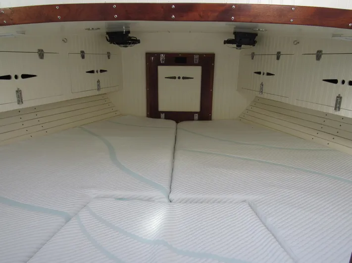 Silverado Yacht Photos Pics Interior cabin of 2009 Custom Pilothouse Cutter with white cushioned bedding.