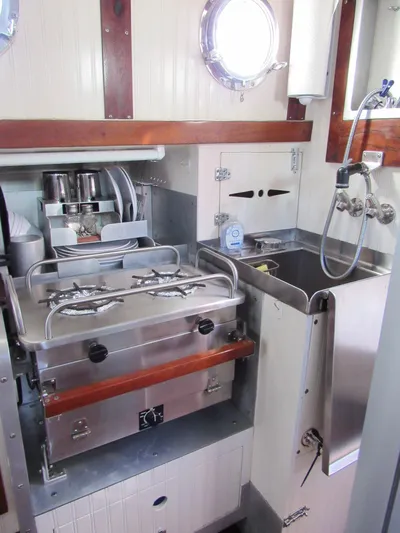 Silverado Yacht Photos Pics Compact galley kitchen in 2009 Custom Pilothouse Cutter with stove and sink.