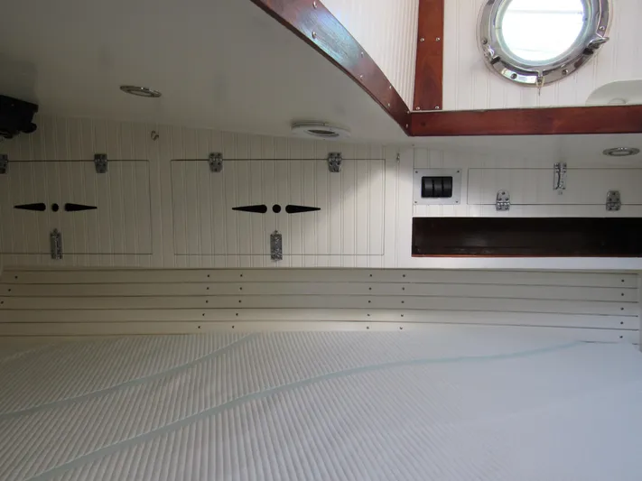Silverado Yacht Photos Pics Interior of 2009 Custom Pilothouse Cutter with white cabinetry and porthole window.