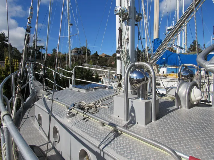 Silverado Yacht Photos Pics Custom Pilothouse Cutter 2009 sailboat deck with rigging and winches under clear blue sky.
