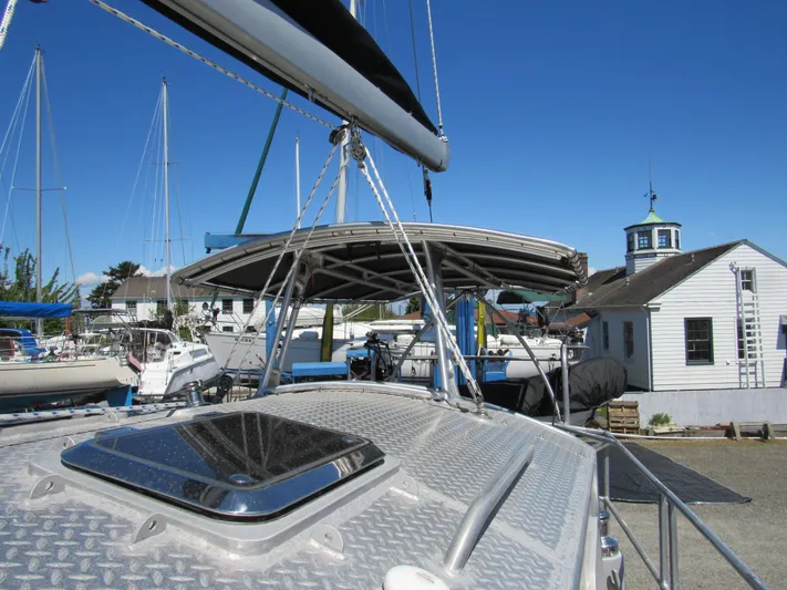 Silverado Yacht Photos Pics Custom 2009 Pilothouse Cutter sailboat docked, featuring a sleek deck and clear blue sky.