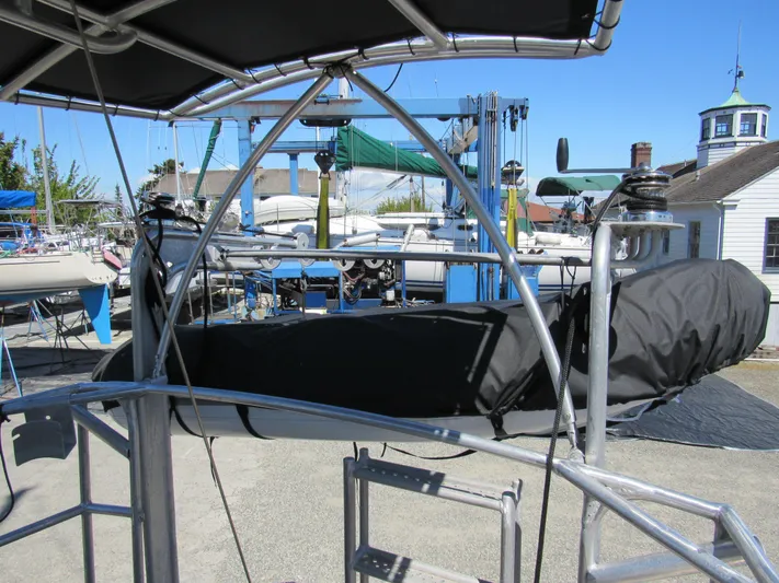 Silverado Yacht Photos Pics 2009 Custom Pilothouse Cutter sailboat in a marina, surrounded by other boats and equipment.