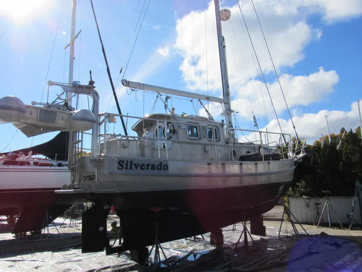 Silverado Yacht Photos Pics 2009 Custom Pilothouse Cutter sailboat on dry dock under a bright blue sky.