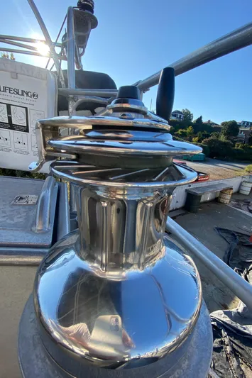 Silverado Yacht Photos Pics Shiny winch on 2009 Custom Pilothouse Cutter sailboat, reflecting sunlight.