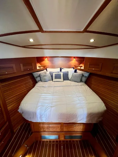 Serendipity II Yacht Photos Pics Luxurious cabin interior of 2010 Sabre 40 Sedan with cozy bed and elegant wood finish.