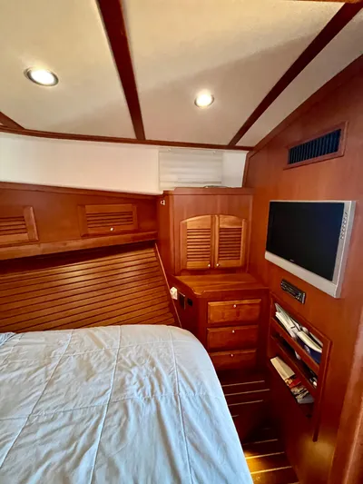 Serendipity II Yacht Photos Pics Interior of 2010 Sabre 40 Sedan with wood paneling, bed, and mounted TV.