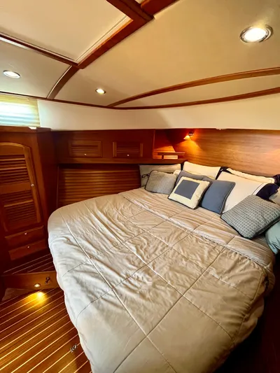 Serendipity II Yacht Photos Pics Luxurious cabin interior of 2010 Sabre 40 Sedan with cozy bedding and wooden accents.