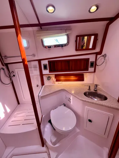 Serendipity II Yacht Photos Pics 2010 Sabre 40 Sedan yacht bathroom with modern fixtures and wood accents.