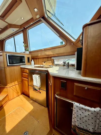Serendipity II Yacht Photos Pics Luxurious 2010 Sabre 40 Sedan yacht interior with modern kitchen and large windows.