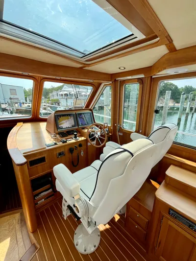 Serendipity II Yacht Photos Pics Interior of 2010 Sabre 40 Sedan yacht with helm, white seats, and navigation equipment.