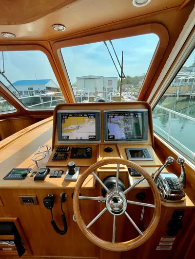 Serendipity II Yacht Photos Pics 2010 Sabre 40 Sedan helm with navigation screens and wooden steering wheel.
