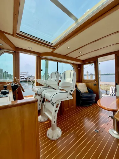 Serendipity II Yacht Photos Pics Luxurious interior of 2010 Sabre 40 Sedan yacht with skylight and elegant seating.