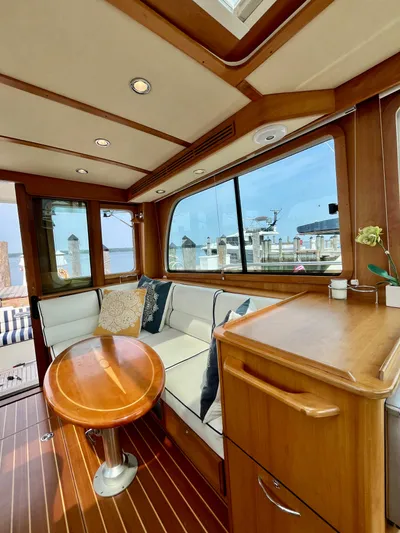 Serendipity II Yacht Photos Pics Interior of 2010 Sabre 40 Sedan yacht with wooden furnishings and waterfront view.