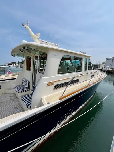 Serendipity II Yacht Photos Pics 2010 Sabre 40 Sedan yacht docked, featuring sleek design and striped seating.