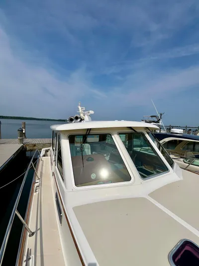 Serendipity II Yacht Photos Pics 2010 Sabre 40 Sedan docked by the water under a clear blue sky.