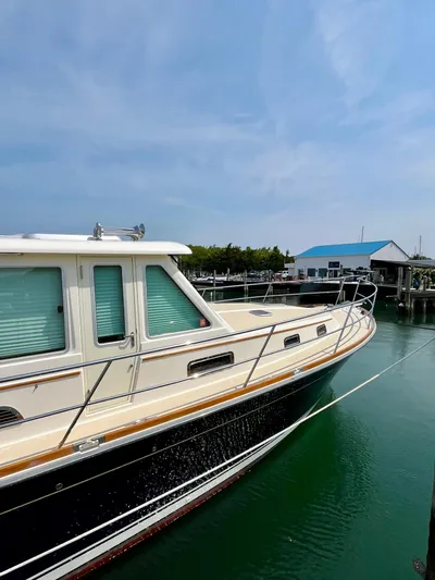 Serendipity II Yacht Photos Pics 2010 Sabre 40 Sedan yacht docked in a marina under a clear blue sky.