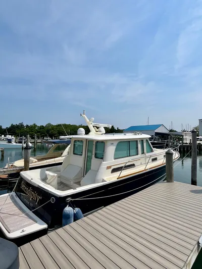 Serendipity II Yacht Photos Pics 2010 Sabre 40 Sedan yacht docked at marina under clear blue sky.