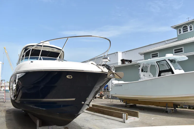 Windy Gale IV Yacht Photos Pics 2011 Sea Ray 310 Sundancer yacht on dry dock beside another boat.