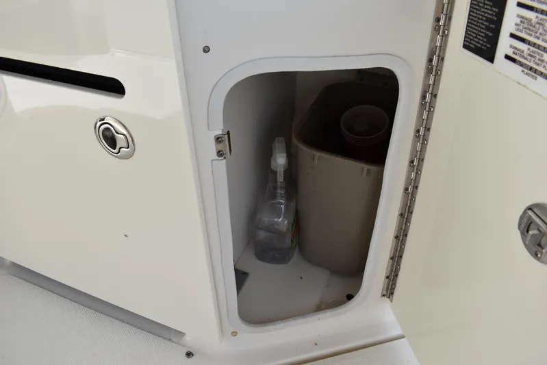 Windy Gale IV Yacht Photos Pics Storage compartment on a 2011 Sea Ray 310 Sundancer boat with cleaning supplies.