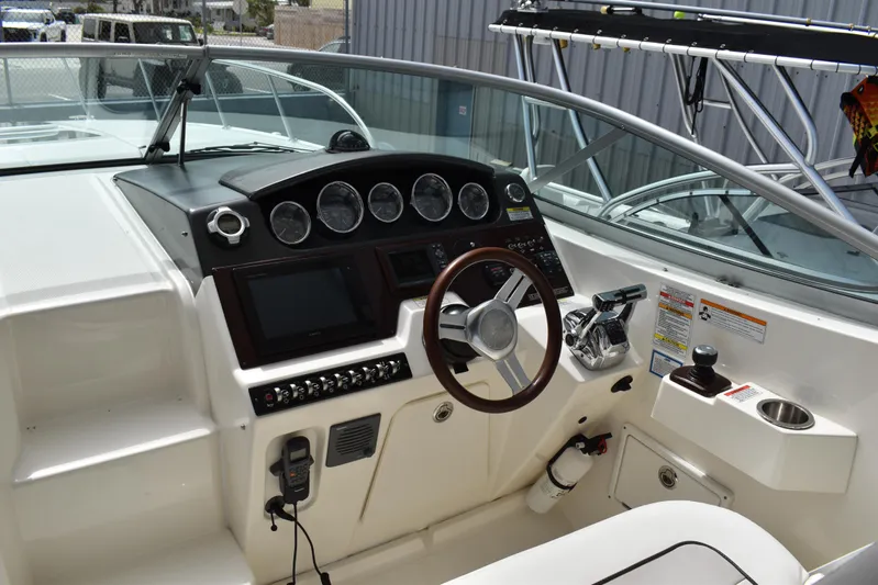 Windy Gale IV Yacht Photos Pics Cockpit of 2011 Sea Ray 310 Sundancer with steering wheel and control panel.
